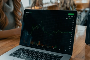 laptop with stock chart and info on screen