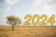 image of a tree in a field with 2024 at the horizon
