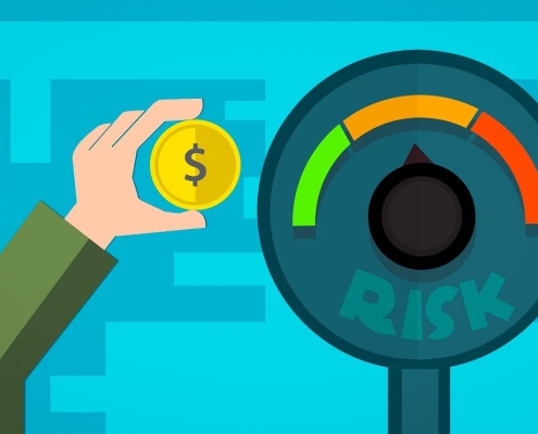 cartoon meter reading "risk" with colors green, orange, red and a hand holding a coin