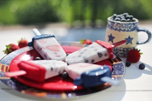 red, white, and blue popsicles on red plate with white and blue mug; 4th of July