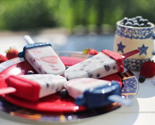 red, white, and blue popsicles on red plate with white and blue mug; 4th of July