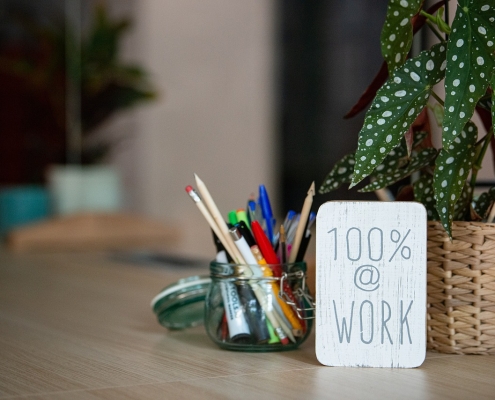 desktop with plant and sign saying 100%; Soft Skills Matter: Work Ethic