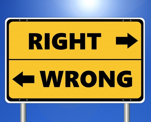 yellow sign with black writing "right" and "wrong" with arrows pointing in different directions: Work Ethic