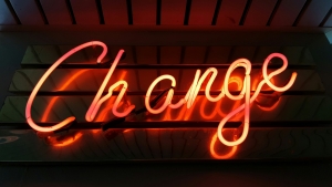 lighted word "change" - sign against a wood background; Carbon Credit and the Changing Energy Market