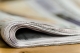 closeup of the end of a folded newspaper; current events January 2025